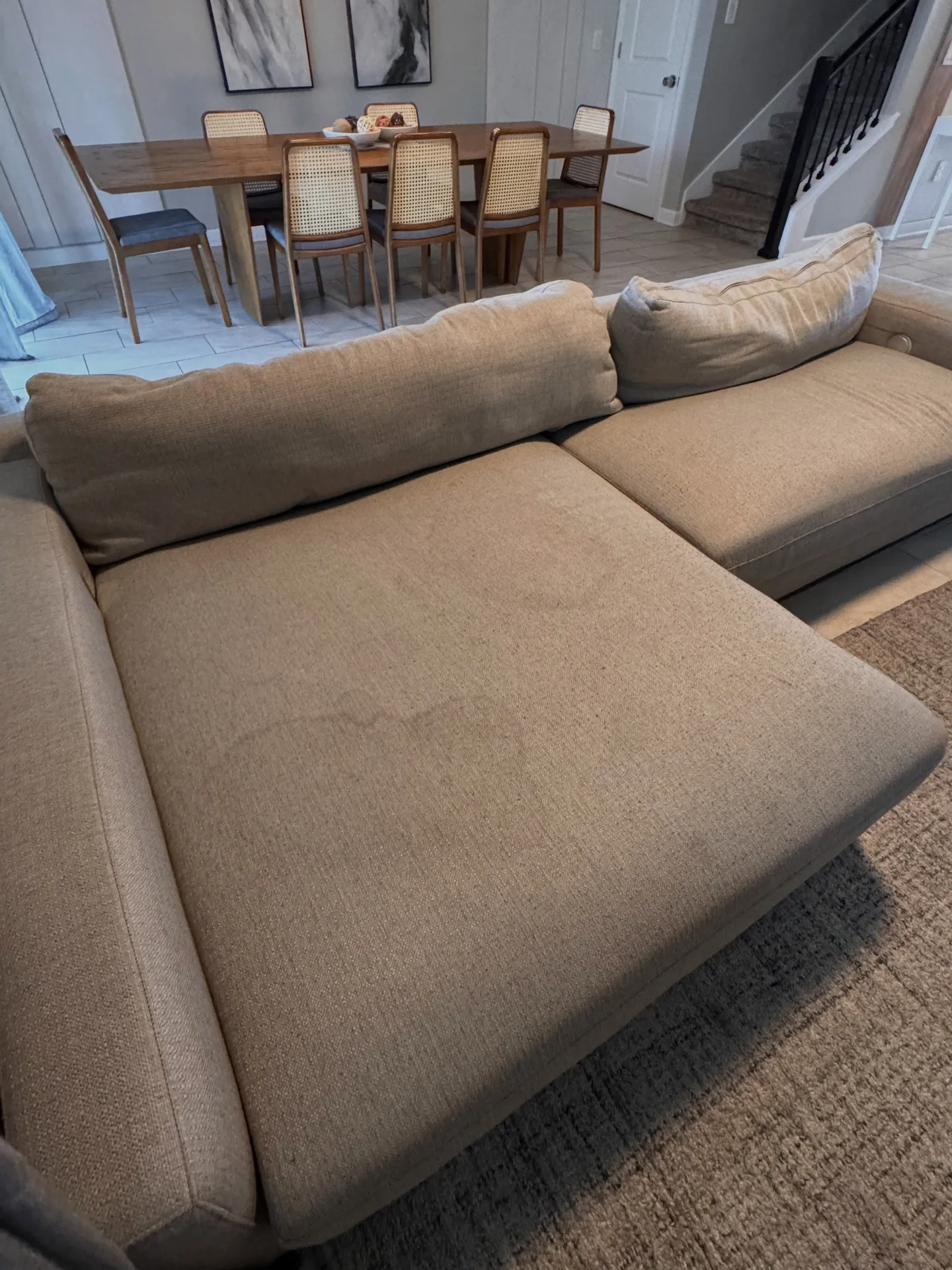 Light sectional sofa from the front angle before professional upholstery cleaning by Everglades Cleaning Solution