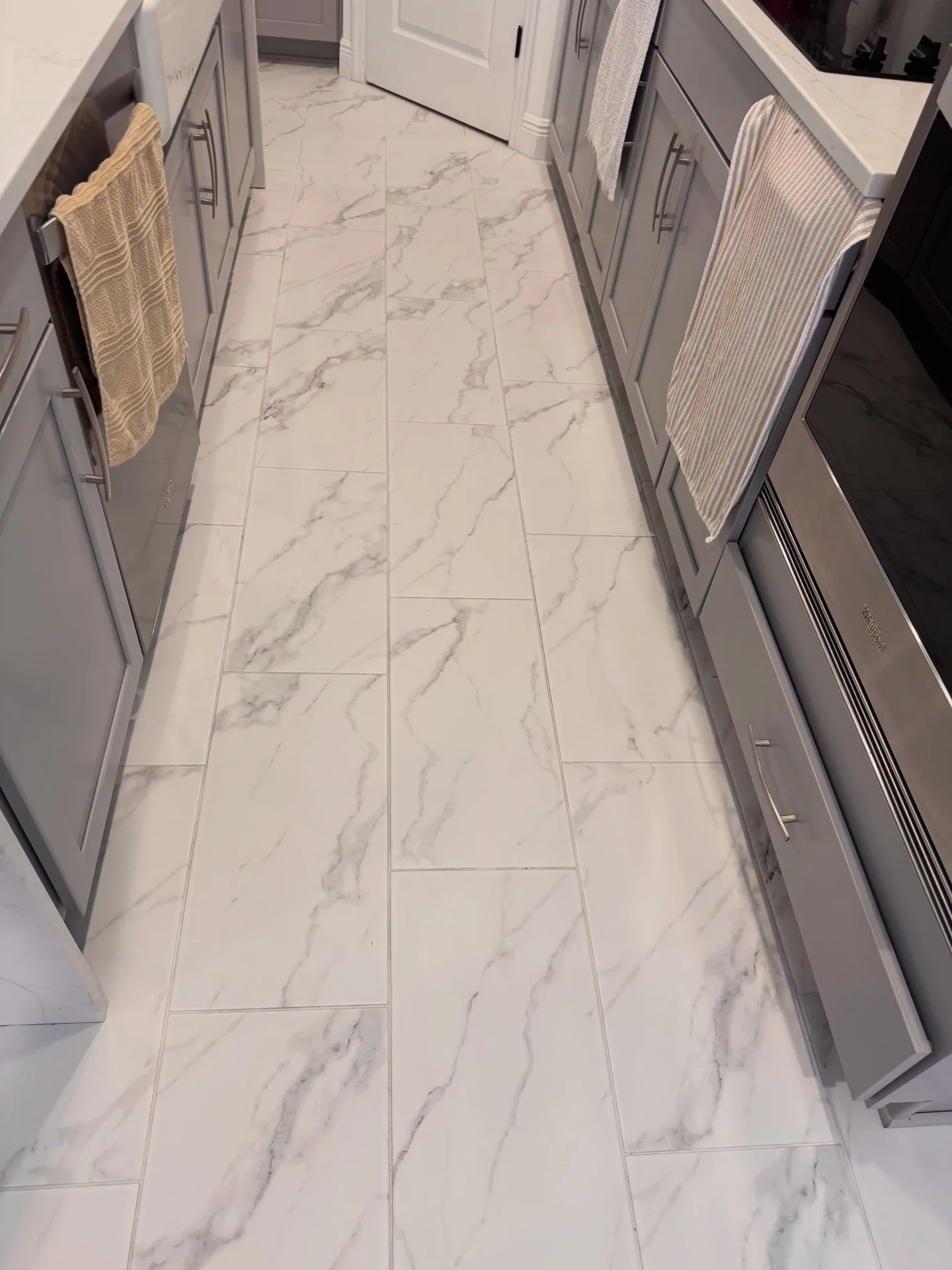 White kitchen tile and grout floor after professional tile & grout by Everglades Cleaning Solution