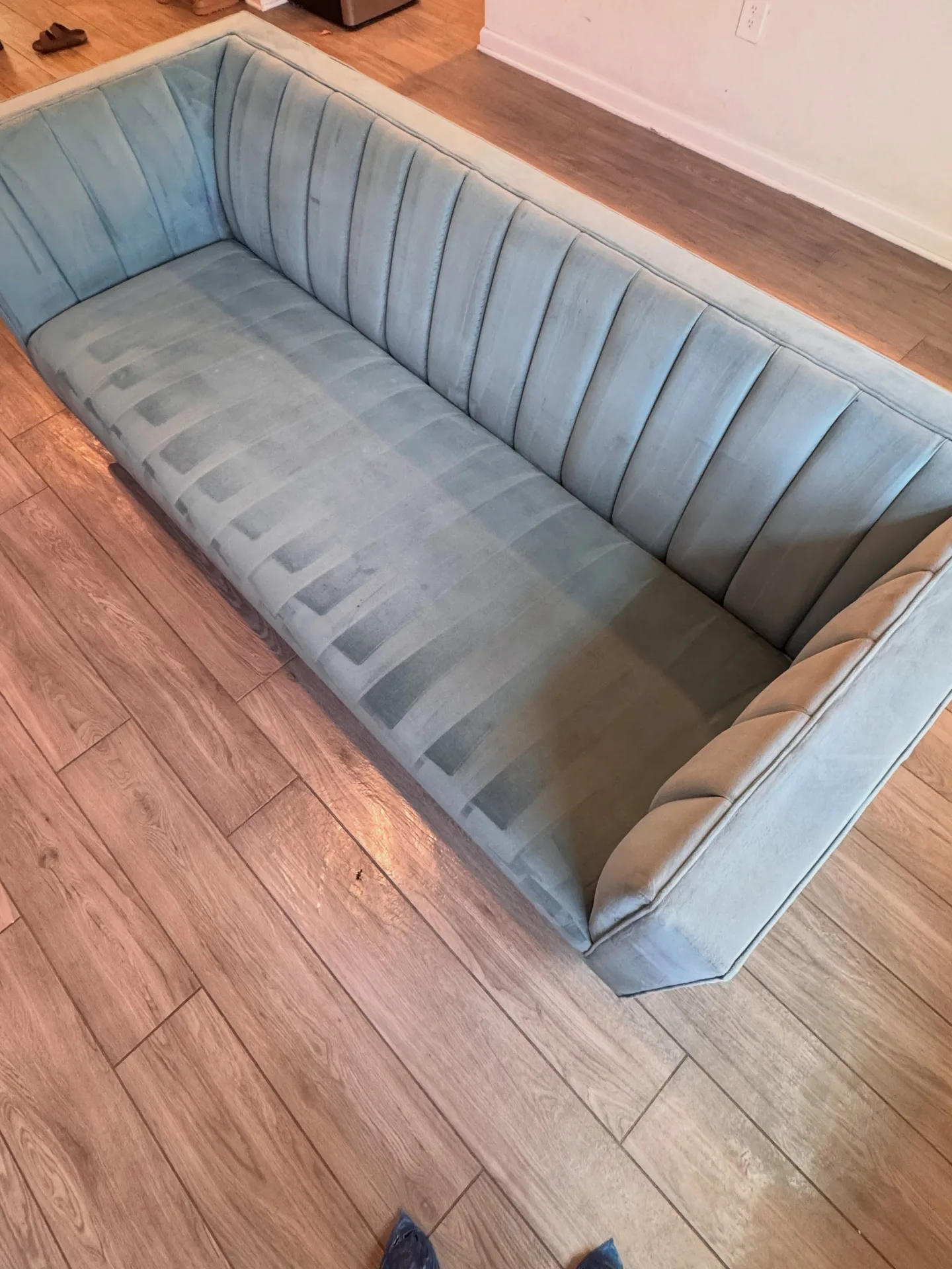 Light sofa with pronounced surface marks after professional upholstery cleaning by Everglades Cleaning Solution