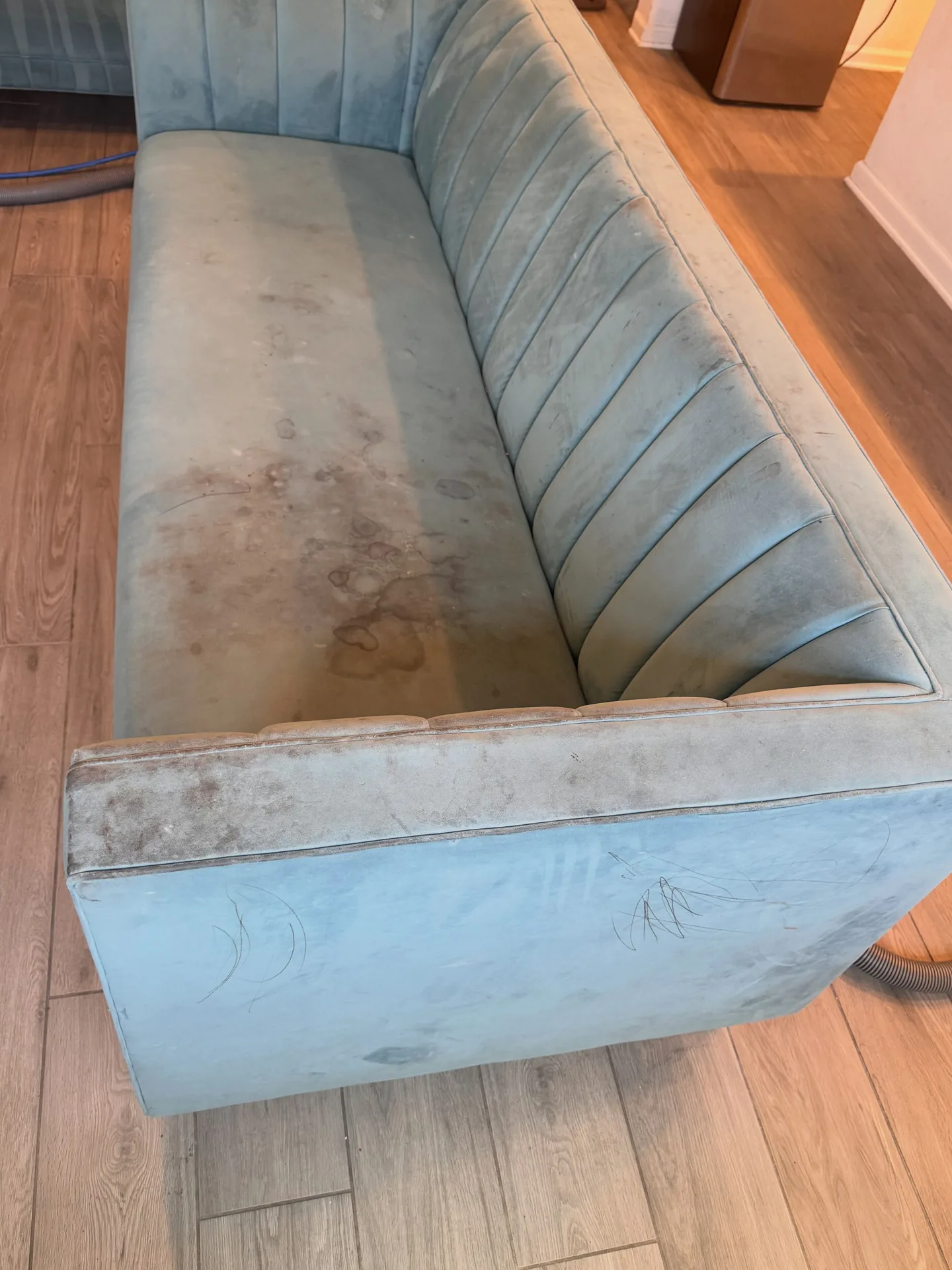 Light sofa with pronounced surface marks before professional upholstery cleaning by Everglades Cleaning Solution